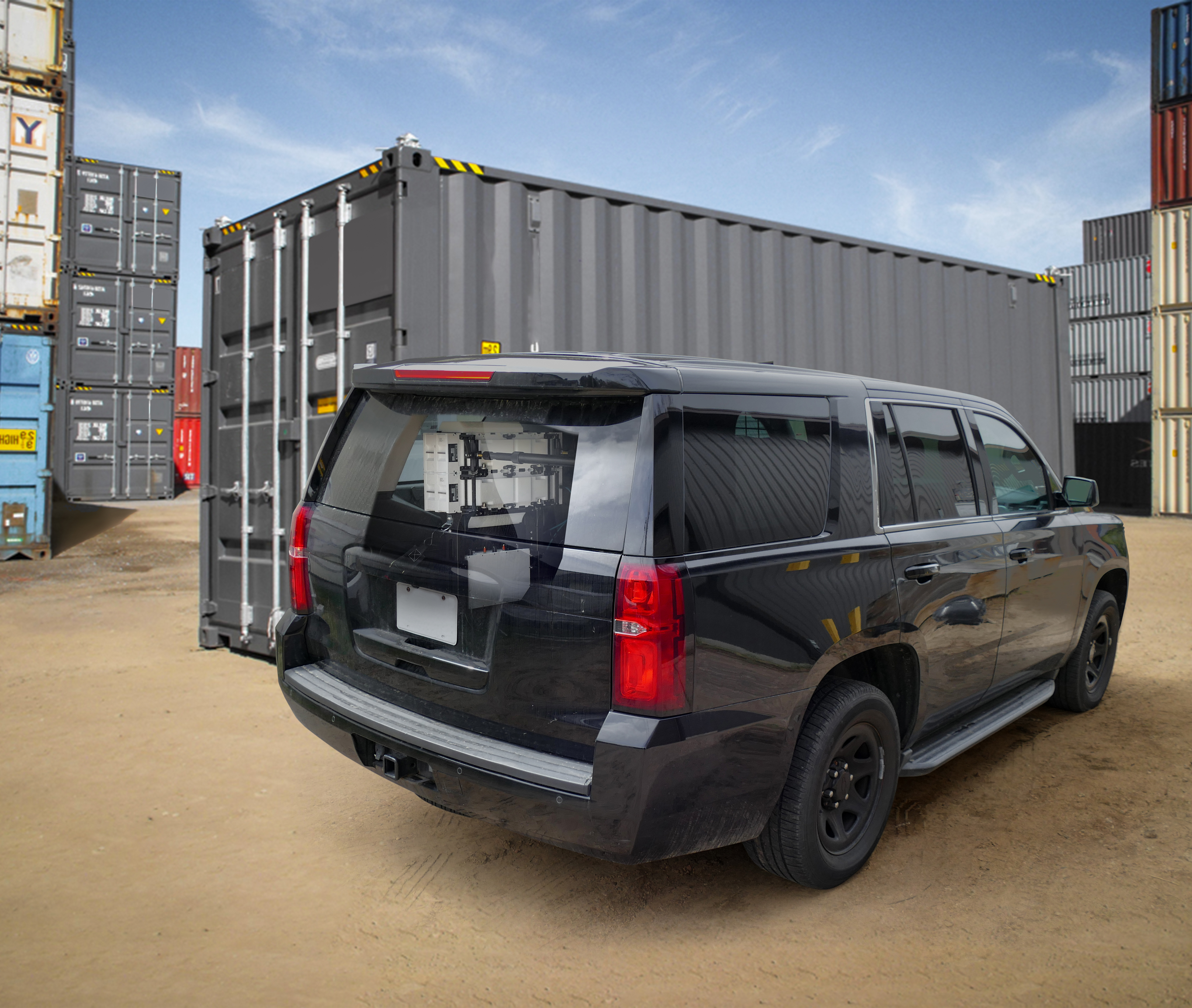SUV parked near a sea container with the FlexSpec x8400 system visible from the window and trunk