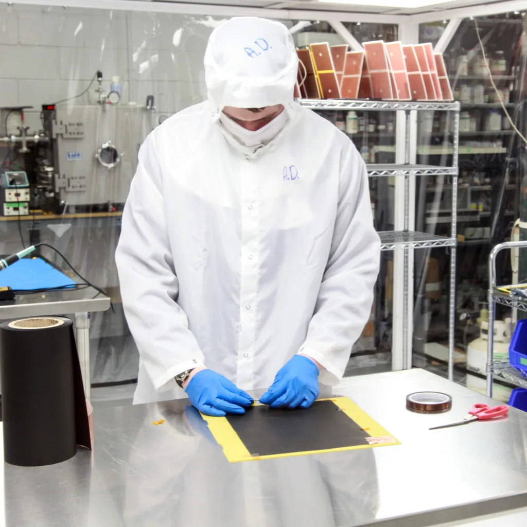 Scientist in a clean room working with electronics