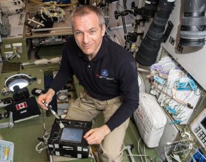 Astronaut David St Jaques conducting experiments using a bubble detector on the international space station.